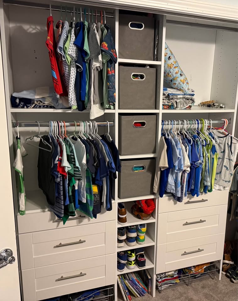 The same white Dakota closet system, fully stocked with folded clothes, hanging shirts, and bins