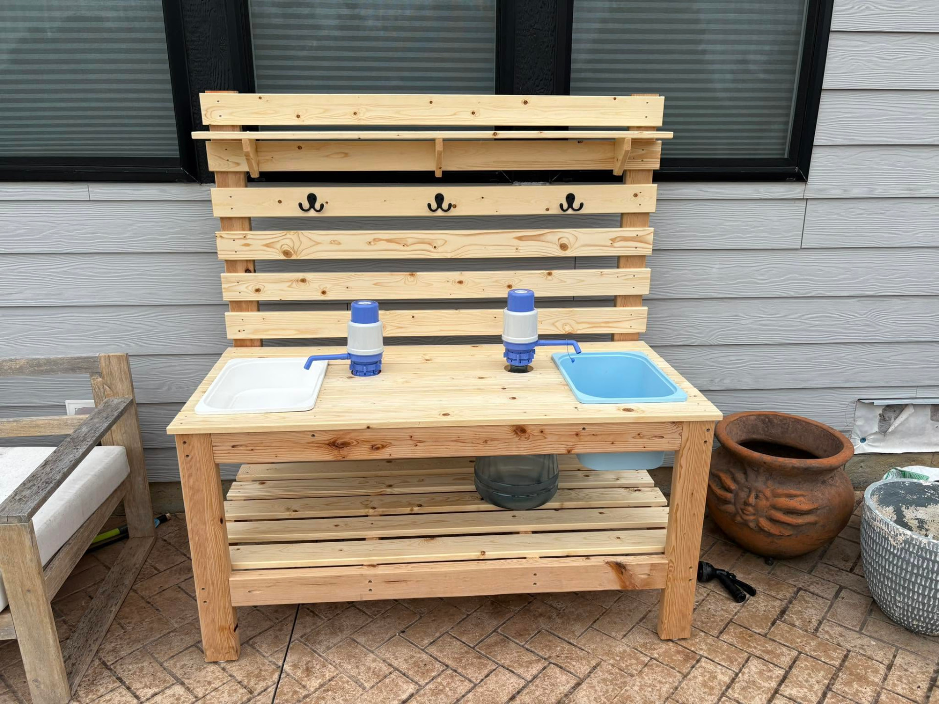 Outdoor pine mud kitchen for kids with two sinks and blue hand water pumps